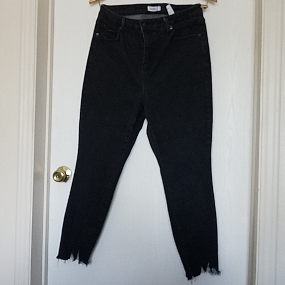 Black tattered hem skinny jeans.
